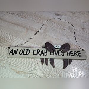 An Old Crab Lives Here Sign